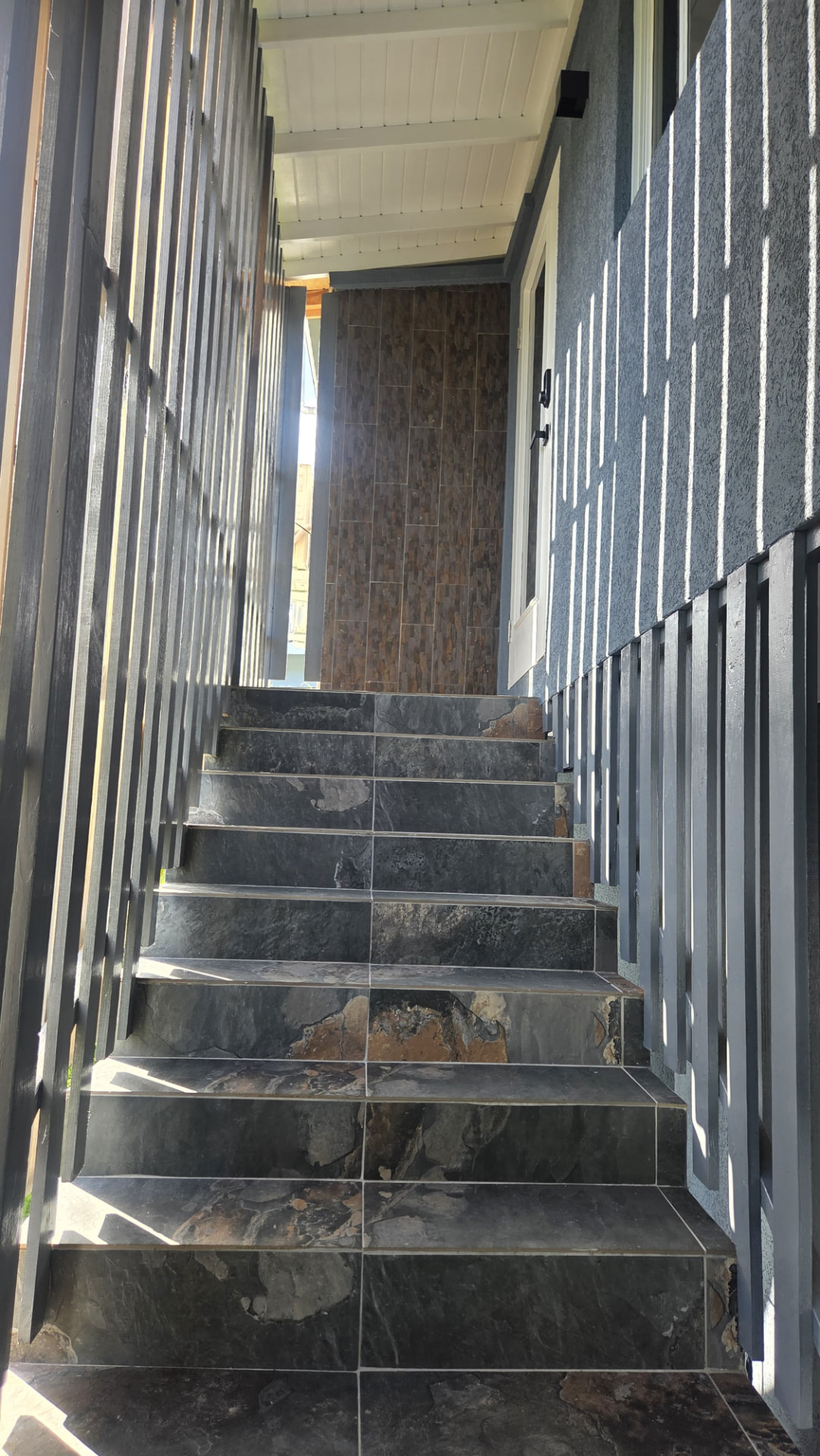 Stone-tiled stairs leading up to the apartment door