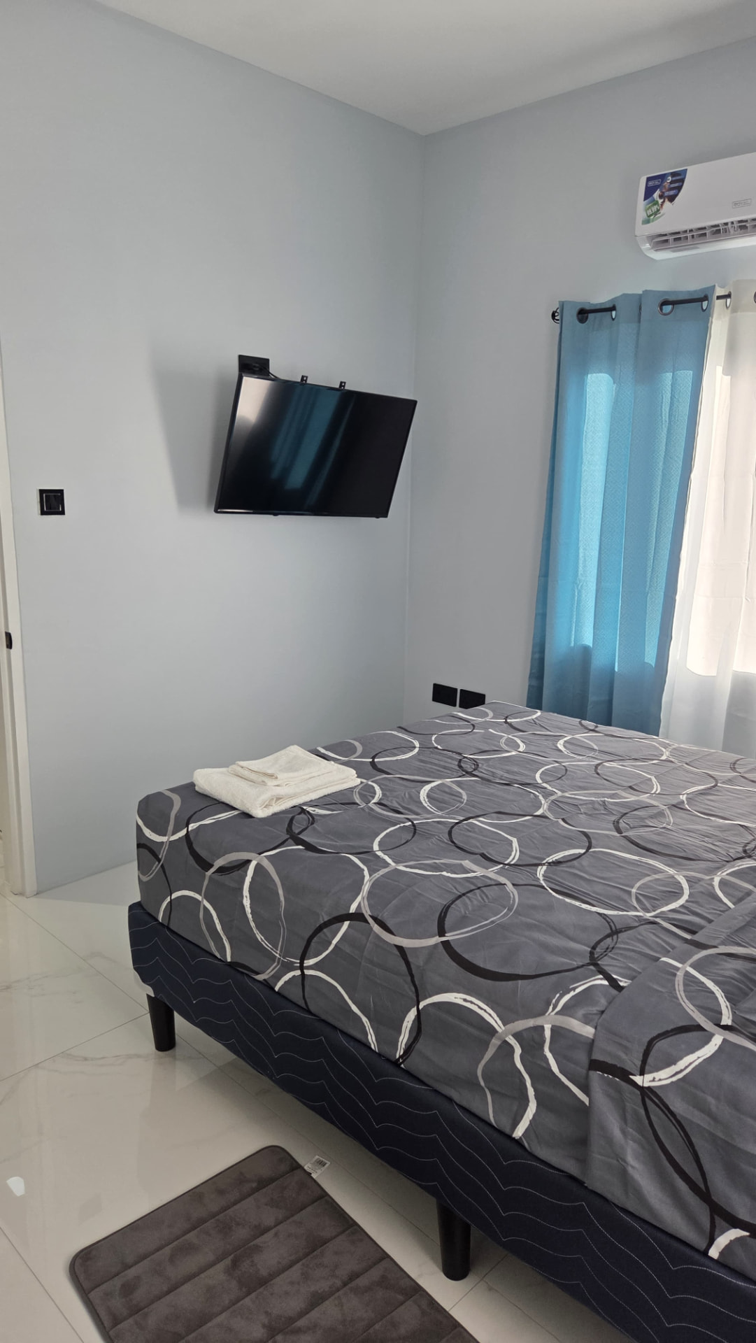 Bedroom seen from the doorway with smart TV