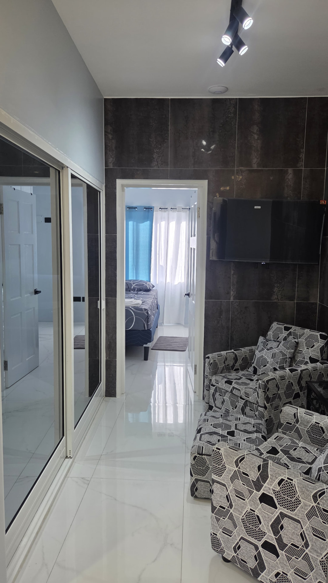 Lounge seating beside the mirrored hallway doors