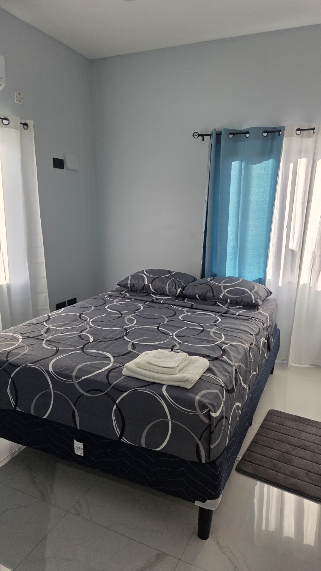 King bed made up in the Azure Breeze Apartment bedroom