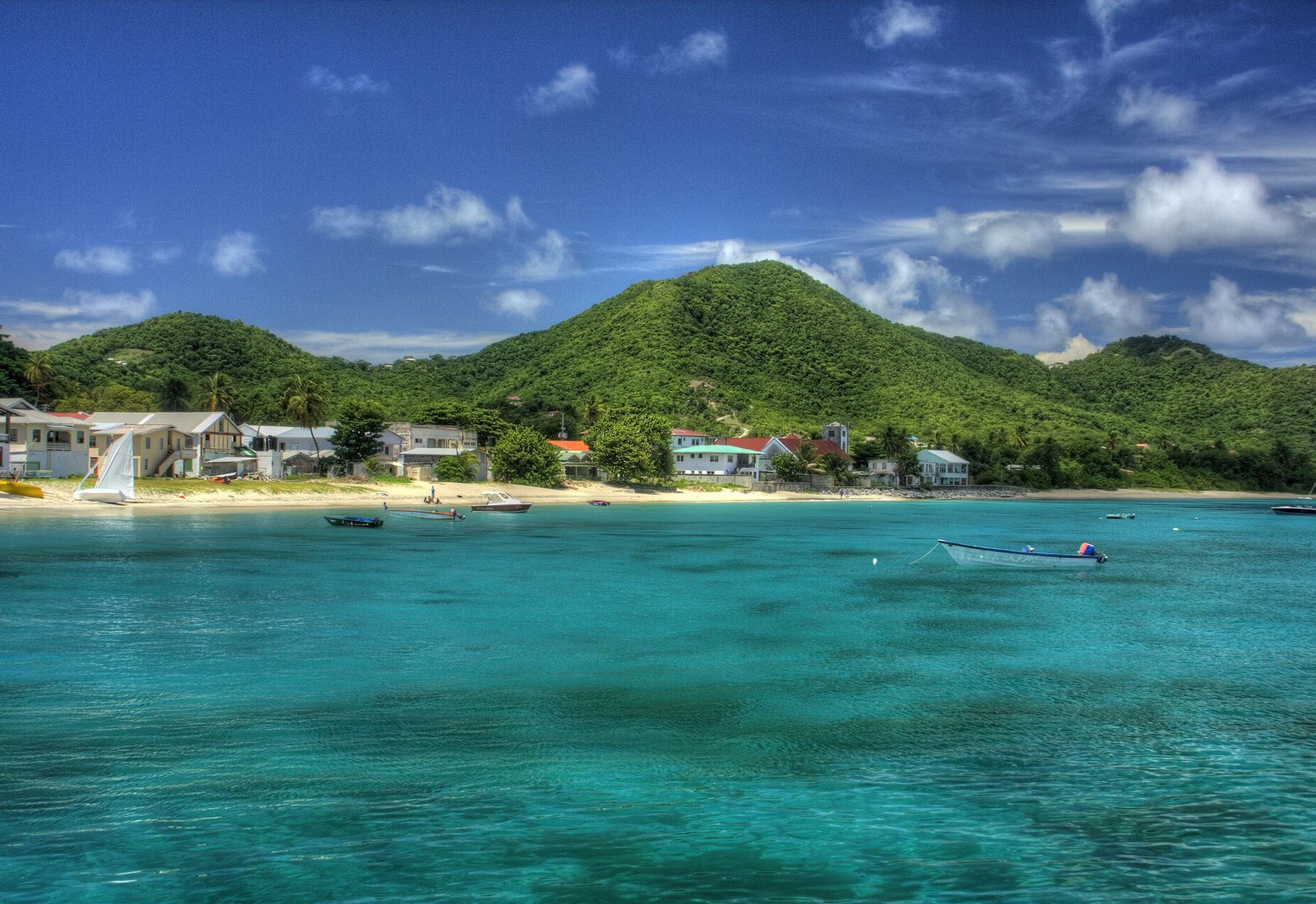 Approaching Carriacou by boat — clear turquoise water and the village of Hillsborough